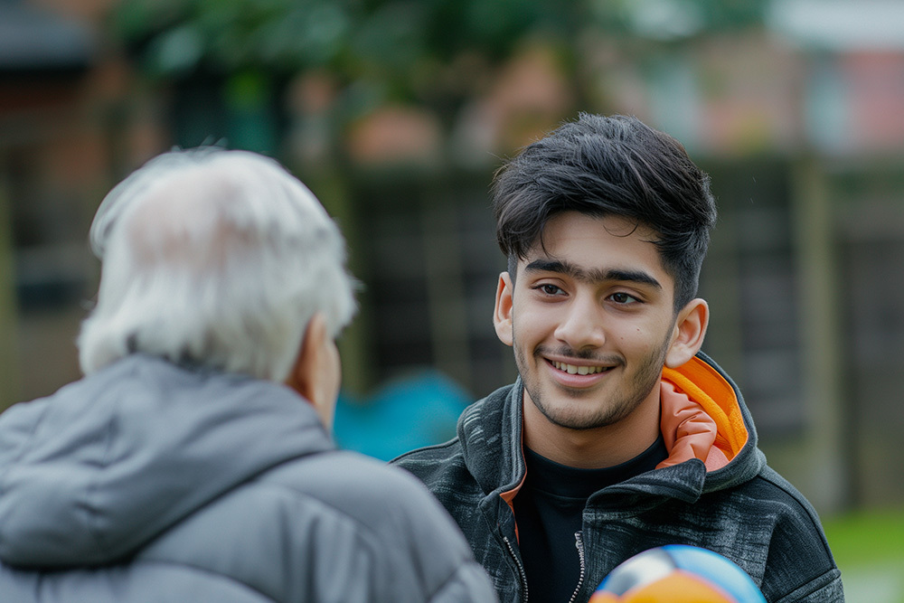 An old person in conversation with an activities worker